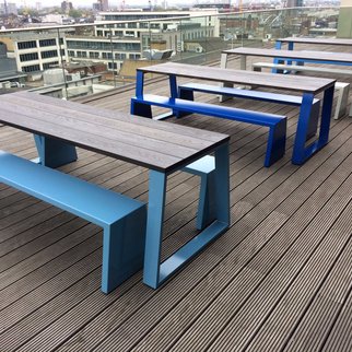 Muzo's Block table with blue legs and benches in rooftop setting