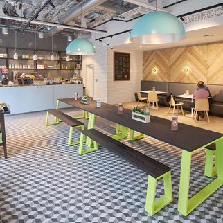 Muzo's Block tables and benches with green legs in cafe