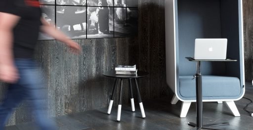 A black Daywalker coffee table with white legs sits in office environment