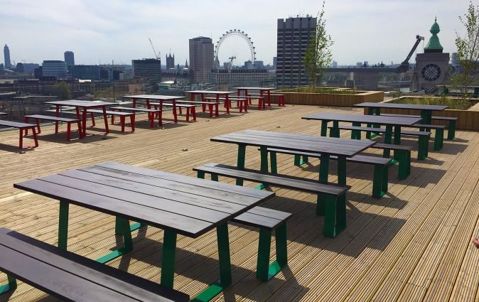 Muzo's Edge tables and benches in rooftop setting