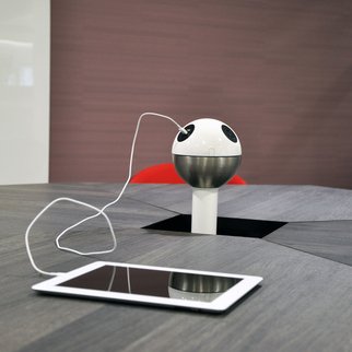 Muzo's Powerball standing charging unit charging tablet on table