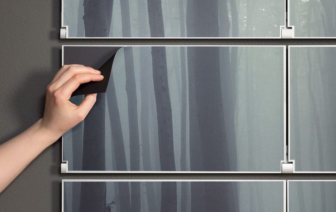 Person peels back fully replaceable art panels on Riveli folding shelving system