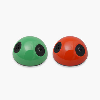 Desktop Powerball charging units in green and red
