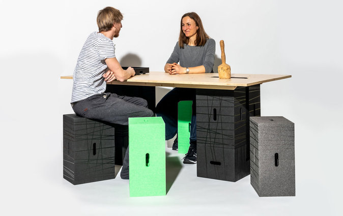 Colleagues chat at an XBrick table